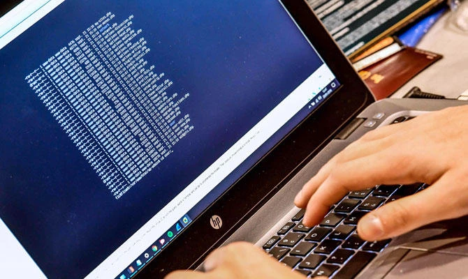 In this file photo taken on January 23, 2018 a person works at a computer during the 10th International Cybersecurity Forum in Lille, France. (AFP)