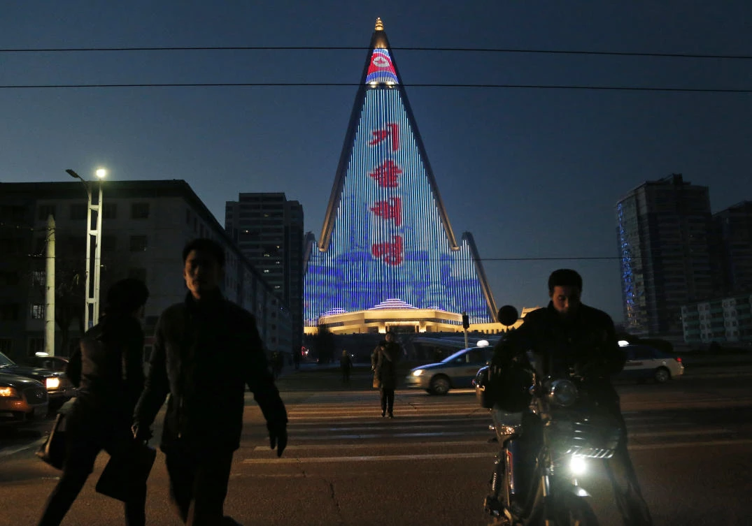 For several hours each night, the building that doesn’t have electricity inside becomes the backdrop of a massive light show in which more than 100,000 LEDs flash images of famous statues and monuments, bursts of fireworks, party symbols, and political slogans. (AP)