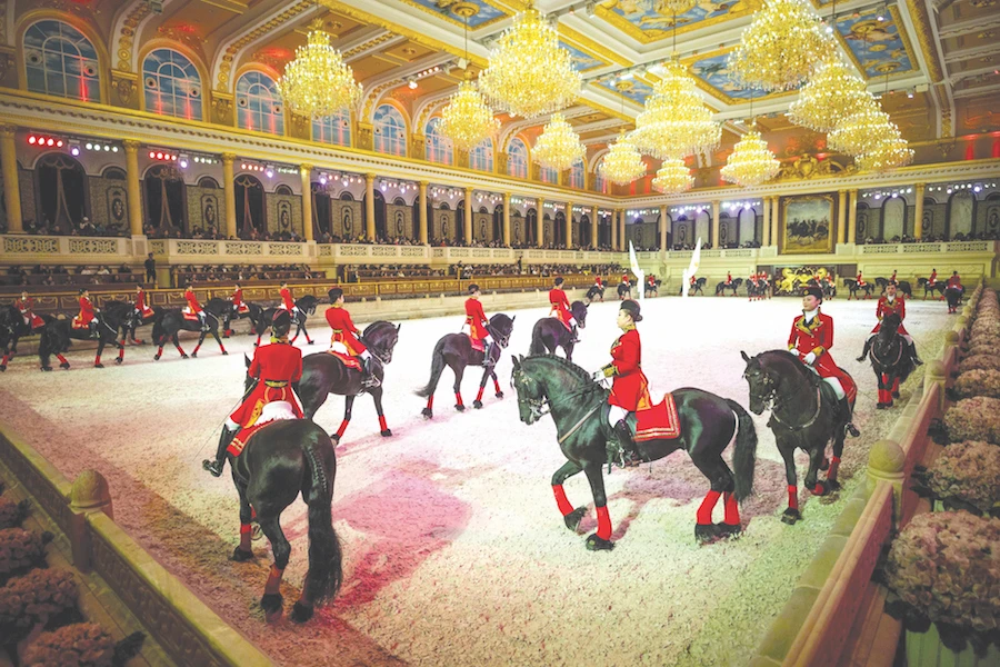 Chinese riders and their horses take part in a performance in the show hall of an equestrian-themed town in Jiangyin, Jiangsu province, northwest of Shanghai. (AFP)