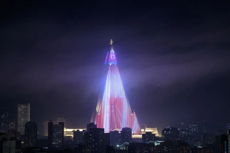 A propaganda message is displayed on the facade of the half-completed pyramid-shaped Ryugyong Hotel in Pyongyang, North Korea, turning a national embarrassment into a symbol of pride. (AFP)