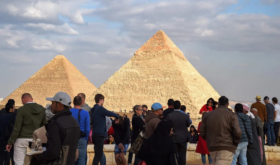 Excited holidaymakers rode camels and queued to enter a tomb as they snapped pictures of the Great Pyramid. (AFP)