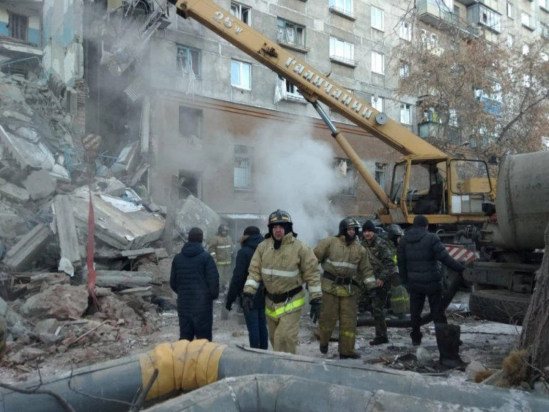 Emergency personnel work at the site of collapsed apartment building after a suspected gas blast in Magnitogorsk, Russia on December 31. (Reuters)