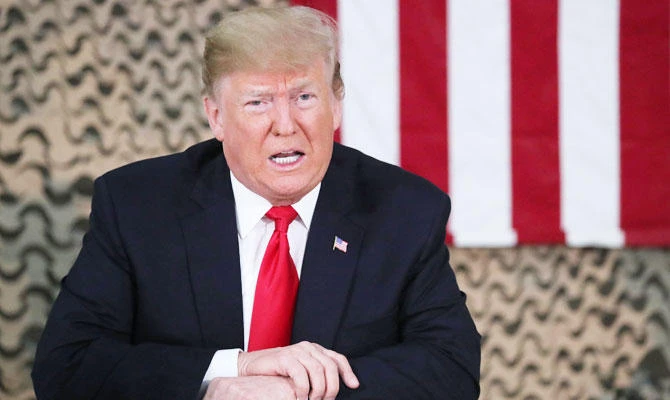 US President Donald Trump speaks to reporters before he meets U.S. political and military leaders during an unannounced visit to Al Asad Air Base, Iraq, December 26, 2018. (REUTERS)