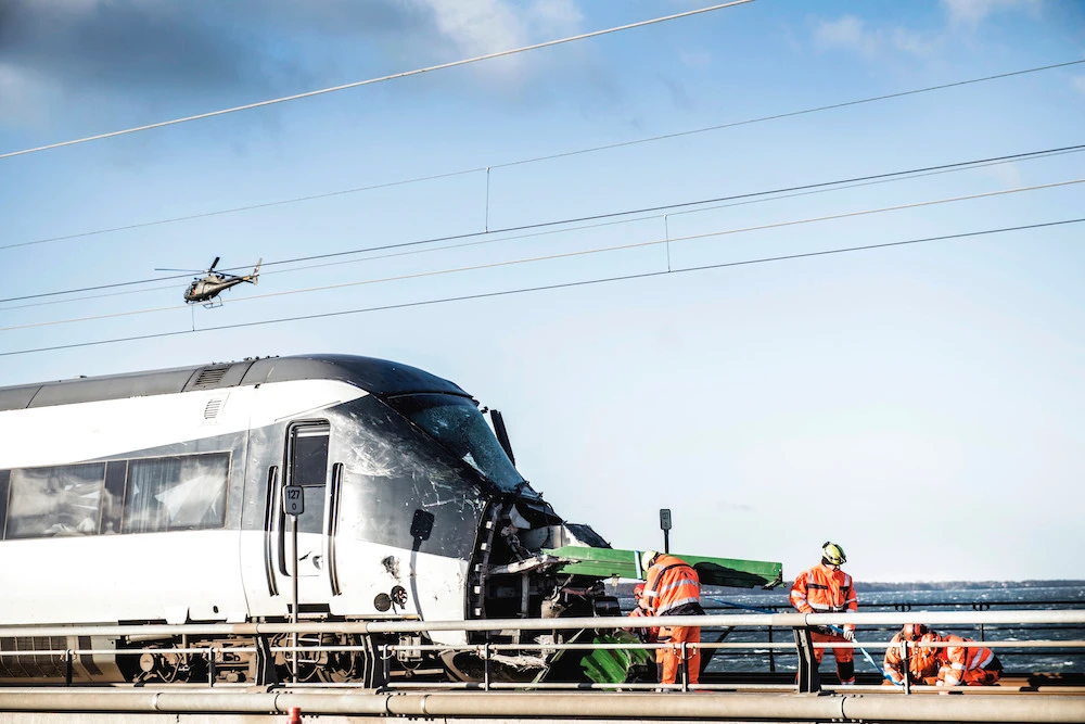 Rescue workers at the site of a train accident on Great Belt Bridge- Storebaeltsbroen, in Nyborg, in Denmark, Wednesday, Jan. 2, 2019. (AP)