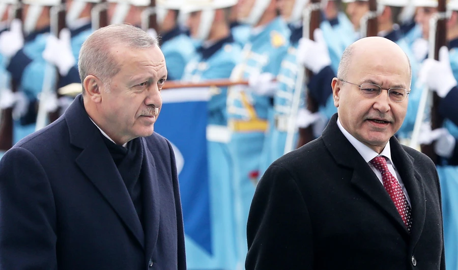 Turkish President Recep Tayyip Erdogan, left, and Iraqi President Barham Salih walk past a guard of honor at the Presidential Complex in Ankara, on Thursday. (AFP)
