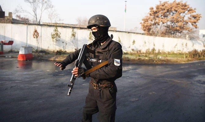 An Afghan policeman stands guard near the entrance gate of the Ministry of Public Works a day after a deadly militant attack in Kabul on December 25, 2018. (AFP)