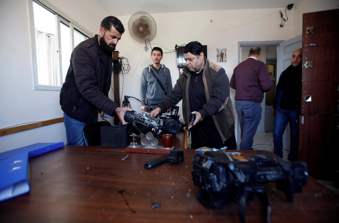 Palestinians inspect damaged equipment inside the office of Palestine TV, in Gaza City January 4, 2019. REUTERS/Ahmed Zakot