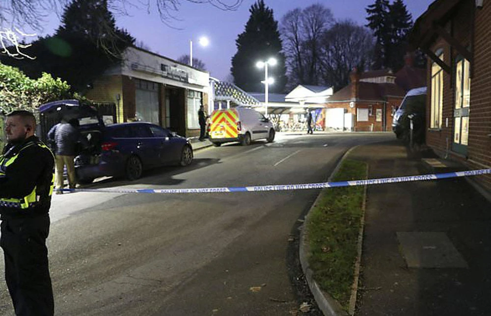 A policeman stands guard at Horsley station following a stabbing on board a London-bound train. (AP Photo)
