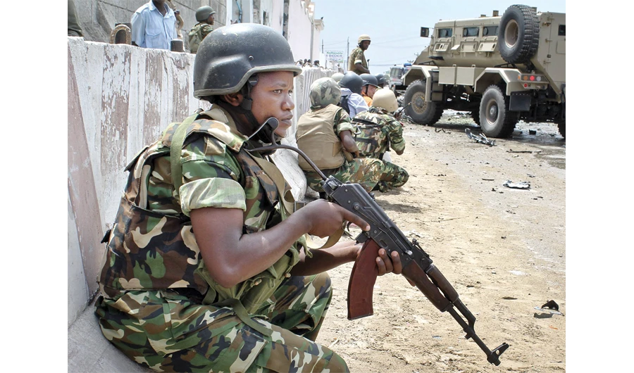 African Union peacekeepers take position during a blast outside the main UN compound. (AP)