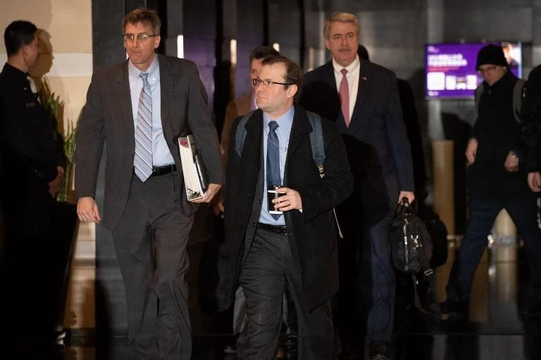 The US trade delegation to China leaves a hotel in Beijing on Monday, January 7, as the two countries seek a deal to end a trade war that has stoked fears of global economic turmoil. (AFP)