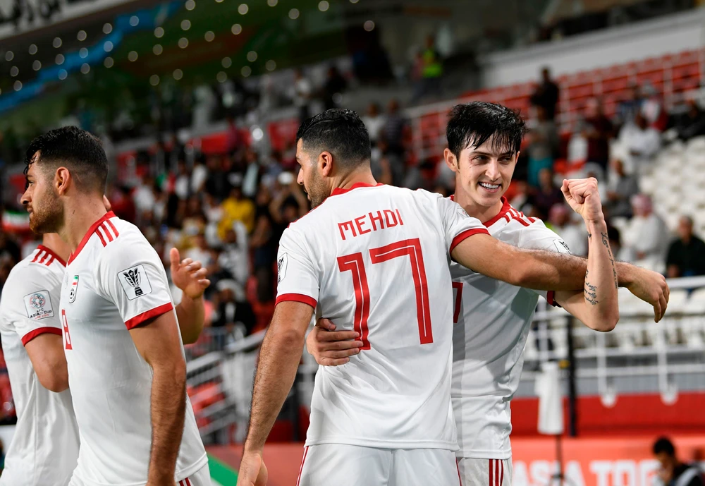 Iran’s forward Sardar Azmoun, right, celebrates after scoring a goal during the 2019 AFC Asian Cup Group D game between Yemen and Iran at the Mohammed Bin Zayed stadium in Abu Dhabi. (AFP)