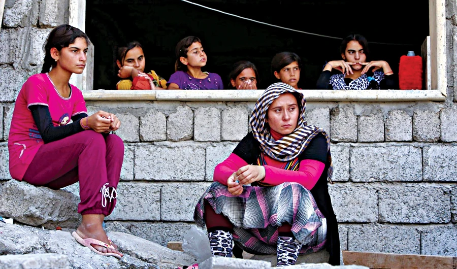 Yazidi women who fled the violence in Iraq take shelter in the city of Dohuk. The Yazidis are a small community which has been often targeted by militants in the region. (AFP)