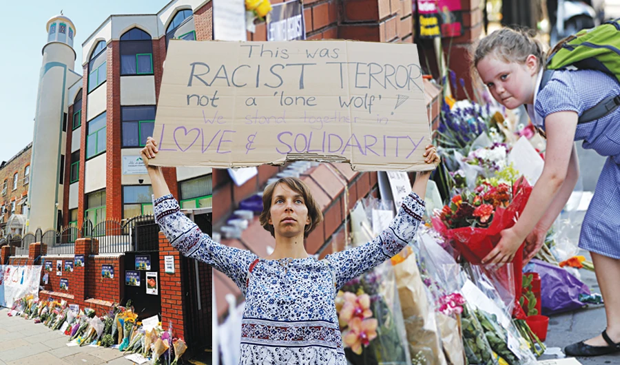 Wreaths outside London’s Finsbury Park mosque in the wake of a June 2017 attack that left one man dead. A protester highlights the growing concern over hate crimes in the
city. (Getty Images)
