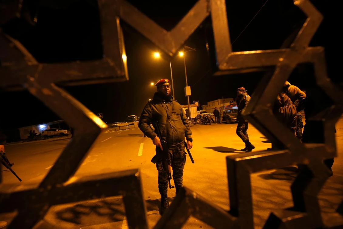 Palestinian security forces stand guard the Rafah border crossing with Egypt on Monday, January 7. (AFP)