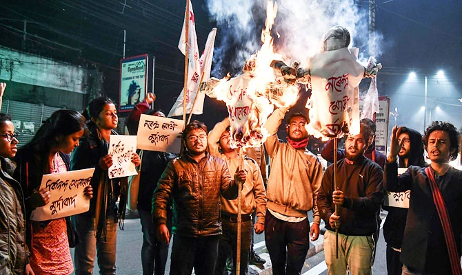 Activists of Students' Federation of India (SFI) burn the effigies of India's Prime Minister and Chief Minister of Assam in Guwahati on January 8, 2019 after India's lower house passed today legislation that will grant citizenship to members of certain religious minorities but not Muslims. (AFP)