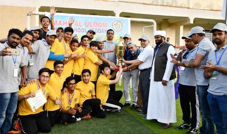 Topaz house with the winners’ trophy at the 10th Annual Sports Meet of Mahd Al-Uloom International School.