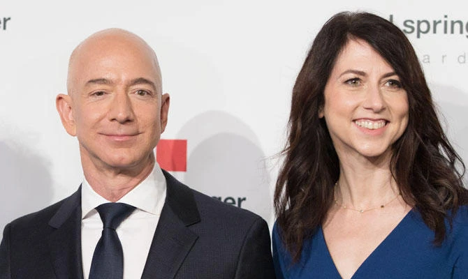 In this file photo taken on April 24, 2018 Amazon CEO Jeff Bezos and his wife MacKenzie Bezos poses as they arrive at the headquarters of publisher Axel-Springer where he will receive the Axel Springer Award 2018 in Berlin. (AFP)