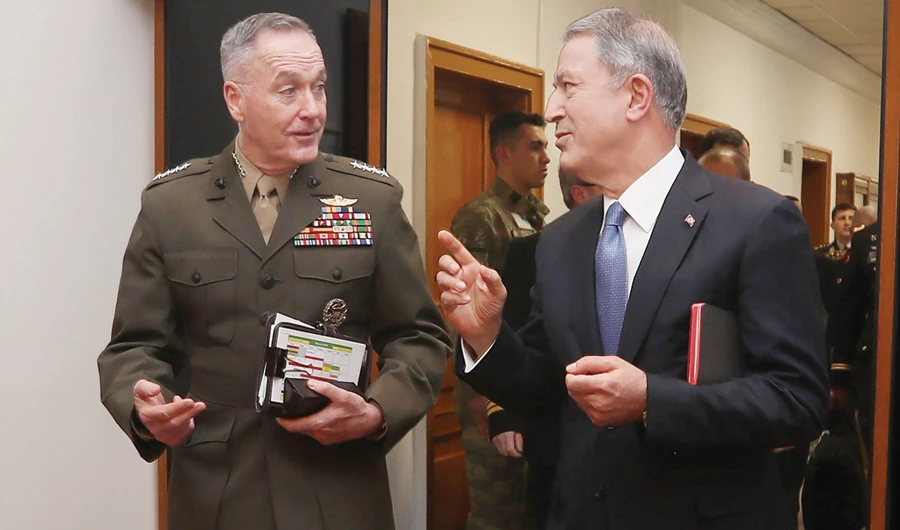 Turkish Defense Minister Hulusi Akar, right, and US Chairman of the Joint Chiefs of Staff Joseph Dunford speak during their meeting in Ankara on Tuesday. (AFP)