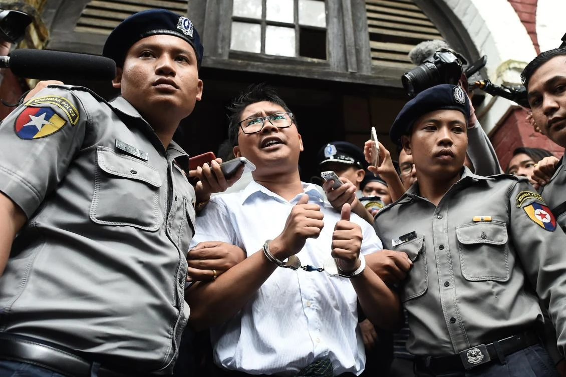 Journalist Wa Lone, center, is escorted by police after being sentenced on September 3, 2018. Wa Lone and fellow Reuters reporter Kyaw Soe Oo’s appeal on the landmark case were denied by a Myanmar court. (AFP)