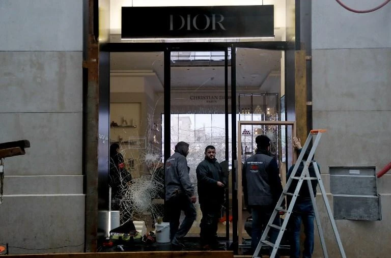 Workers repair the Dior shop window on the Champs-Elysees avenue in Paris on November 25, 2018 after yellow vest protestors smashed the boutique and stole a million euros worth of goods. (AFP)