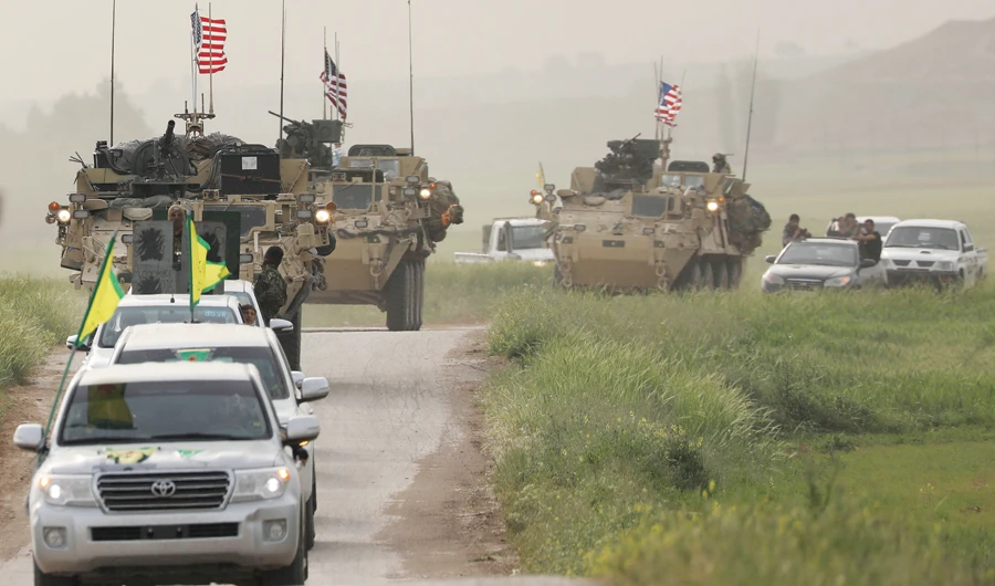 YPG rebels head a convoy of US vehicles in the town of Darbasiya. (Reuters)_