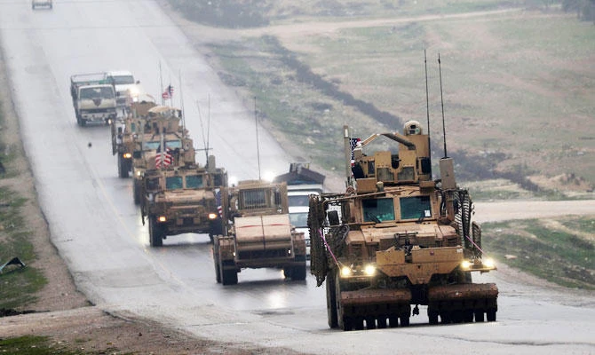 In this file photo taken on December 30, 2018 a convoy of US military vehicles rides in Syria's northern city of Manbij. (AFP)