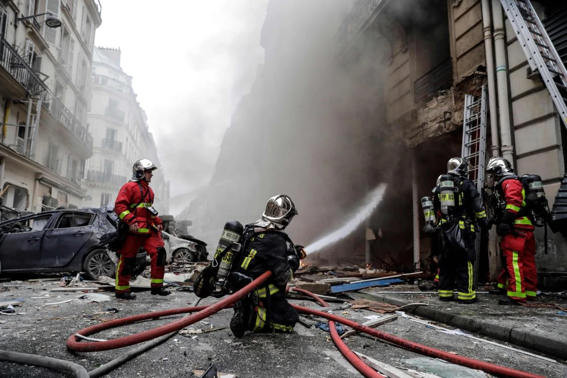 Firefighters extinguish a fire after the explosion of a bakery on the corner of the streets Saint-Cecile and Rue de Trevise in central Paris on Saturday, January 12, 2019. (AFP)