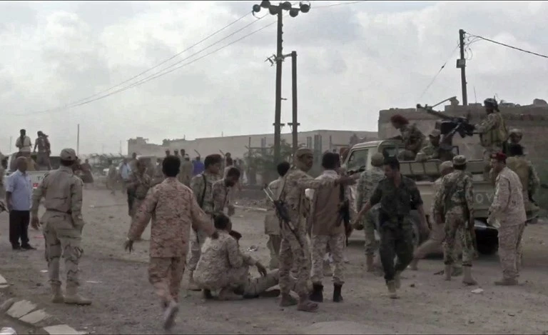 An image grab taken from a video obtained by AFPTV shows Yemeni soldiers reacting after a drone exploded above Yemen's al-Anad airbase in the government-held southern province of Lahj on January 10, 2019. (AFP)
