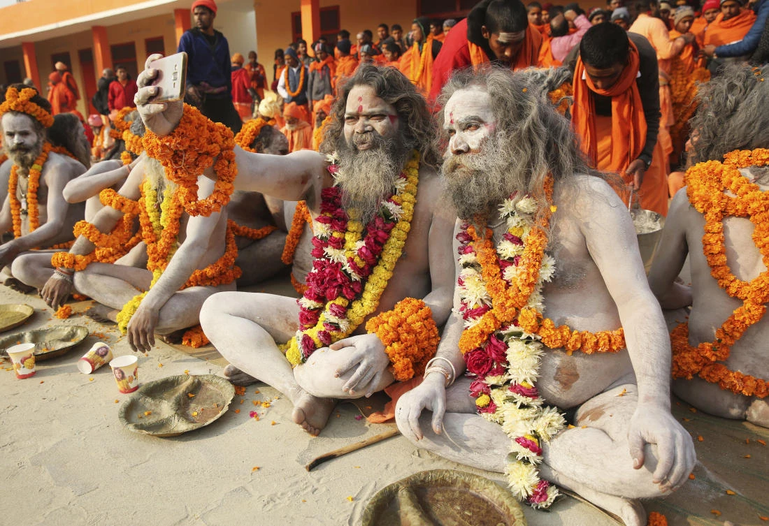 Naga sadhus, or naked Hindu holy men, take a selfie before participating in a procession toward the Sangam, the confluence of rivers Ganges and Yamuna, during the first ‘royal entry’ for the Kumbh Mela in Allahabad, India on January 1. (AP)