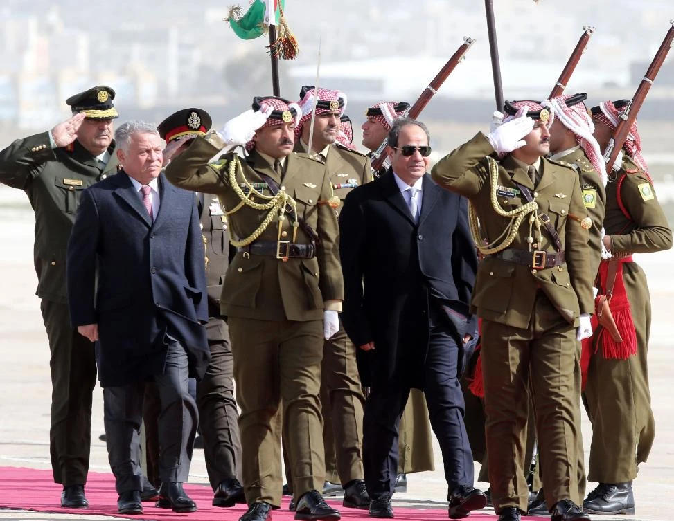 King Abdullah II of Jordan (L) and Egyptian President Abdel Fattah El-Sisi review an honor guard at Marka International Aiport, in the Jordanian capital Amman on January 13, 2018. (AFP)