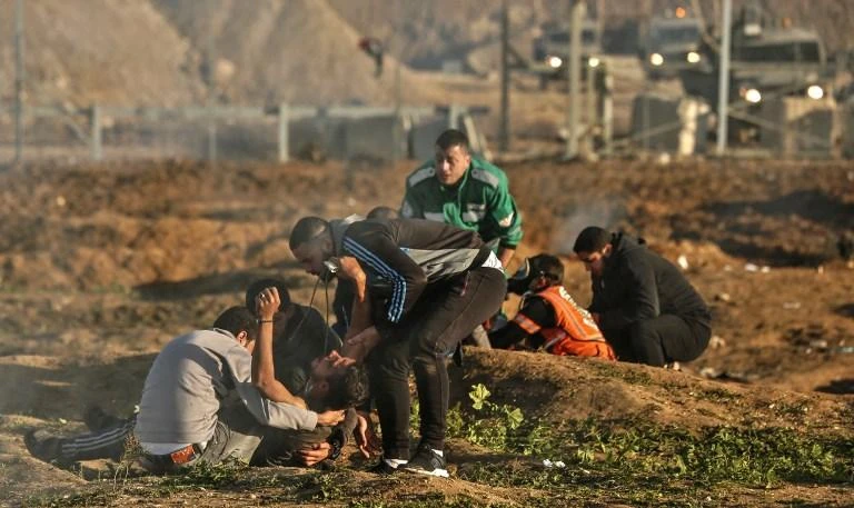 Palestinians evacuate an injured protester during clashes with Israeli forces over the weekend along the Gaza border with Israel. (AFP)