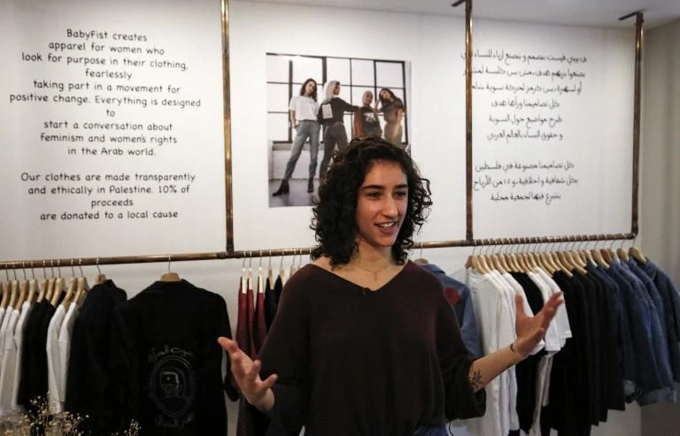Palestinian designer Yasmeen Mjalli started painting slogans on her own clothes when the family relocated to the West Bank. (AFP)