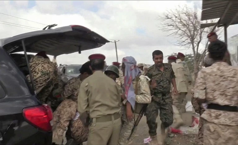 Yemeni soldiers evacuate the injured after a Houthi drone exploded above Yemen’s Al-Anad airbase, which killed six soldiers, in the government-held southern province of Lahj on January 10. (AFP)