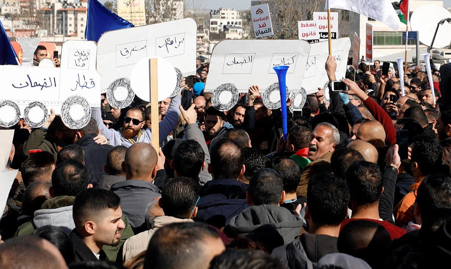 Palestinians take part in a protest against a social security law in Ramallah, in the Israeli-occupied West Bank, on Jan.15, 2019. (REUTERS/Mohamad Torokman)