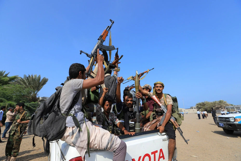 In this file photo, newly recruited Houthi fighters chant slogans as they ride a military vehicle during a gathering in the capital Sanaa. (AFP)