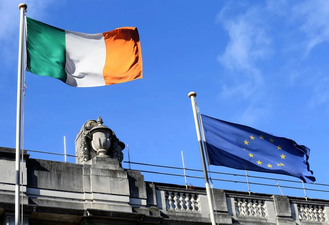 Ireland is seen as the EU member state most vulnerable to the threat of an unruly exit by Britain. Above, an Irish national flag, left, flies alongside a European Union (EU) flag in the centre of Dublin. (AFP)