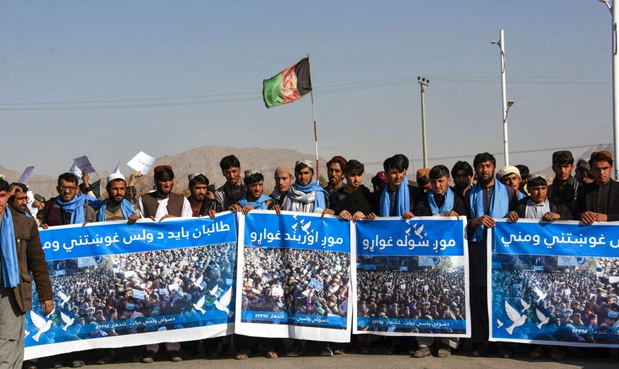 Afghan protesters march for peace and and an end to violence and criminality as they hold banners in the Kandahar province on January 17, 2019. (AFP/JAVED TANVEER)