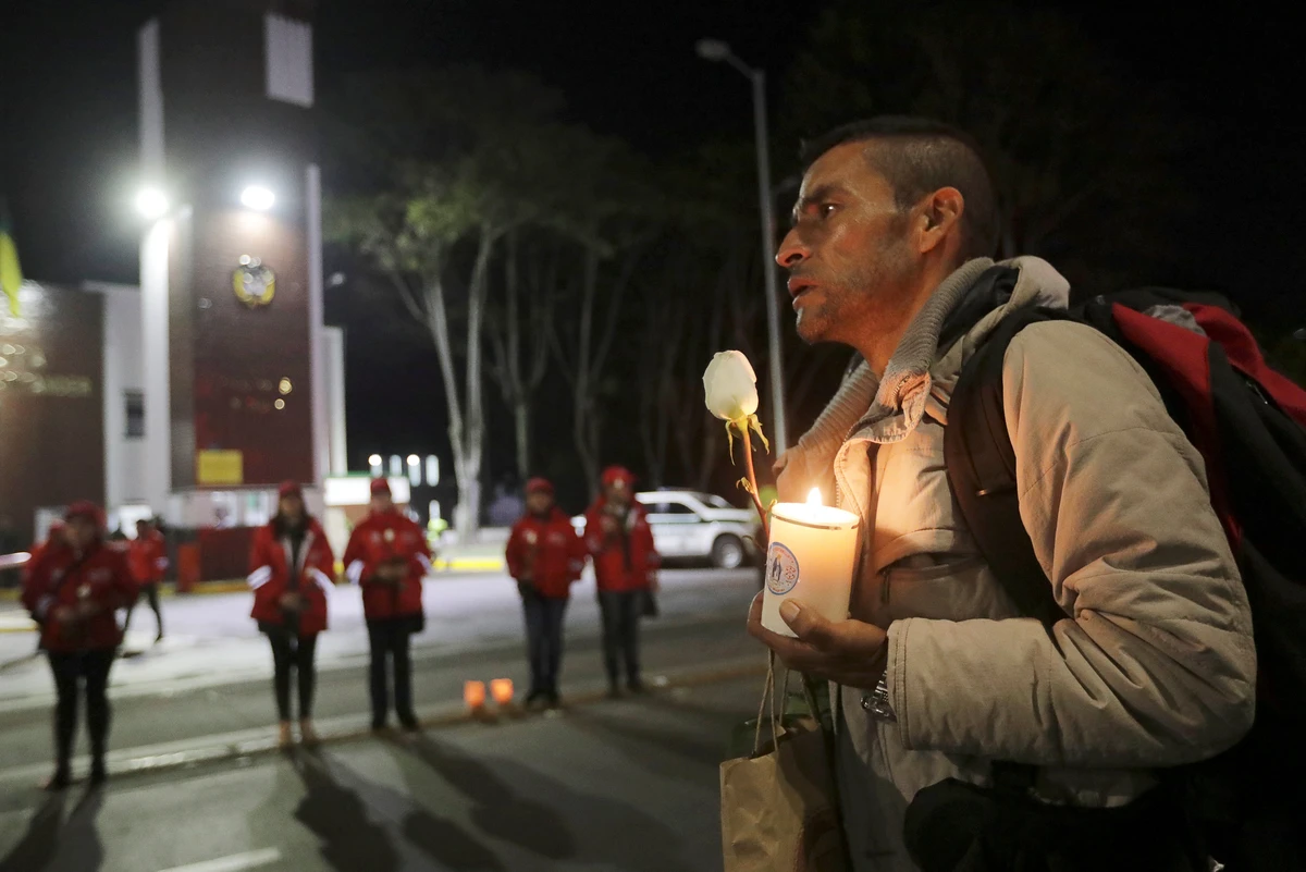 A man takes part in a candlelight vigil to honor victims, close to the scene of a car bomb explosion, in Bogota, Colombia on January 17. (Reuters)