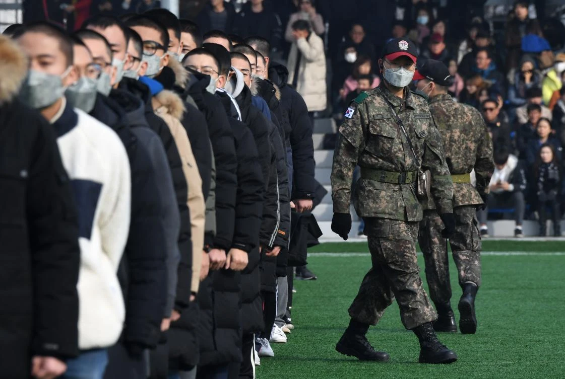 South Korean soldiers check new military conscripts during an induction ceremony at the army training center in Nonsan. (AFP)