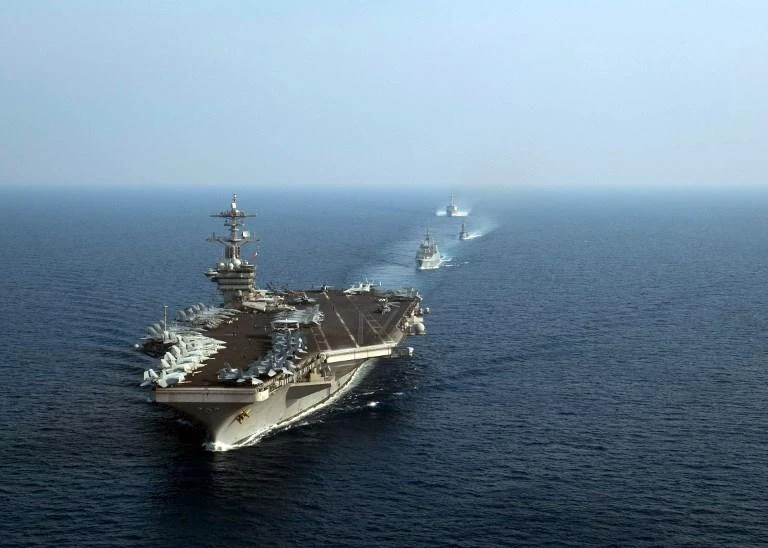 The aircraft carrier USS Theodore Roosevelt leads a formation of US and Singapore ships in the South China Sea on April 6, 2018. (Navy Office of Information/AFP)