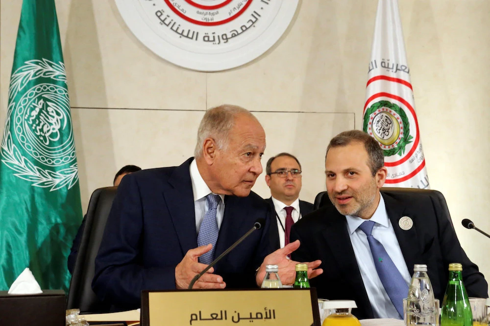 Arab League Secretary-General Ahmed Abul Gheit gestures as he talks with Lebanese Foreign Minister Gebran Bassil, at a pre Arab Economic and Social Development summit meeting in Beirut, Lebanon January 18, 2019. (Reuters)