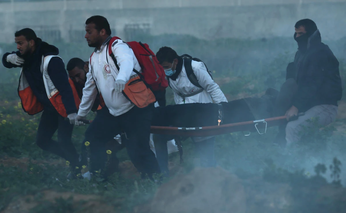 Israeli fire wounds 14 as thousands of Palestinians protest at Gaza border