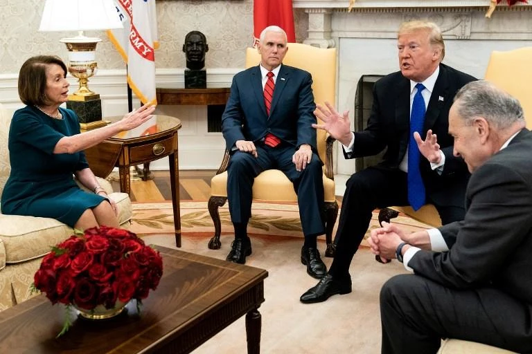US Vice President Mike Pence (2L) listens while Democratic US Representative Nancy Pelosi (L), US President Donald Trump (2R) and Democratic Senate Minority Leader Charles Schumer argue about the impending government shutdown during a meeting at the White House in Washington, DC. (AFP)