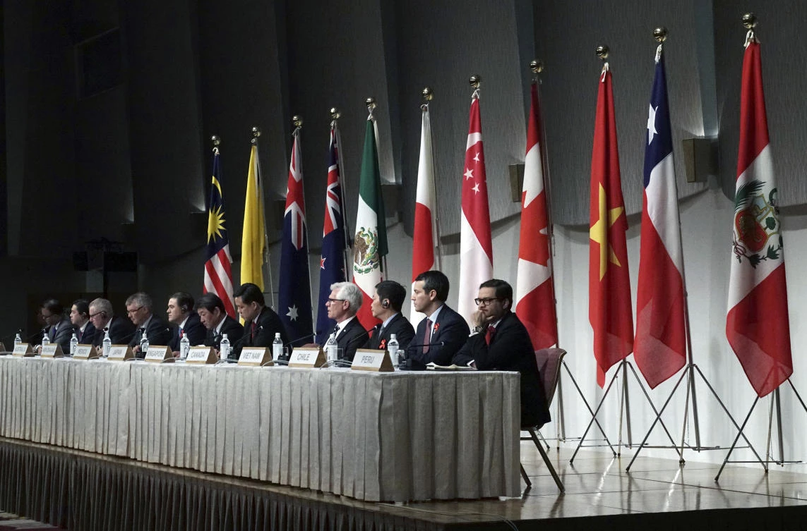 Toshimitsu Motegi, Japan’s minister of economy, trade, and industry, sits with other ministers and delegates of a Pacific Rim trade bloc, attend a joint press conference after a session of the Comprehensive and Progressive Trans-Pacific Partnership (CPTPP) in Tokyo Saturday, Jan. 19, 2019. (AP)