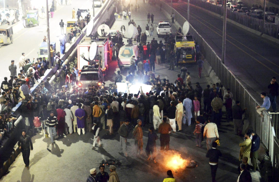 Relative and local residents burn tires and block a main road to protest against the killing of a family by counter-terrorism officers, in Lahore, Pakistan, on Jan. 19, 2019. (AP Photo/K.M. Chaudary)
