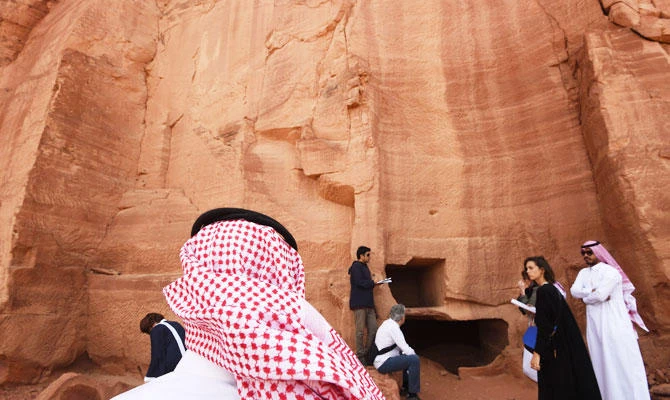 A photo taken on March 31, 2018 shows a Saudi man standing at the entrance of a tomb at Madain Saleh, a UNESCO World Heritage site, near Saudi Arabia's northwestern town of al-Ula. (AFP)