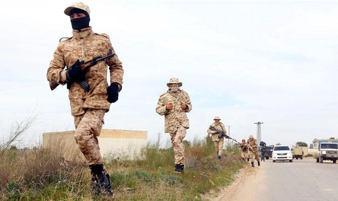 Members of the Tripoli Protection Force, an alliance of militias from the capital city, patrol an area south of the Libyan capital on January 18, 2019, during clashes with the Seventh Brigade group from the town of Tarhuna. (AFP)