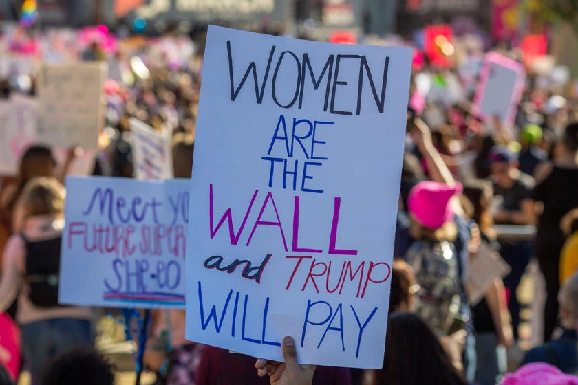 A placard draws a comparison with the Trump-proposed wall between the United States and Mexico during the Third Annual Women's March LA in downtown Los Angeles, California on January 19, 2019. Thousands of women gathered across the United States for their annual message opposing Donald Trump and supporting women's rights. (AFP / DAVID MCNEW)