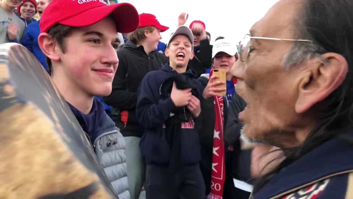 A student from Covington Catholic High School stands in front of Native American Vietnam veteran Nathan Phillips in this still image from a video by Kaya Taitano. (Kaya Taitano via Reuters)