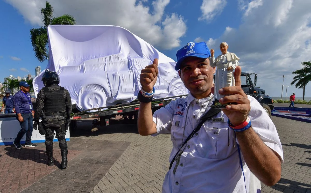 A pilgrim holds a figurine of Pope Francis during the presentation in Panama City of the popemobile that will be used by Francis during his upcoming visit to participate in the World Youth Day. (AFP)